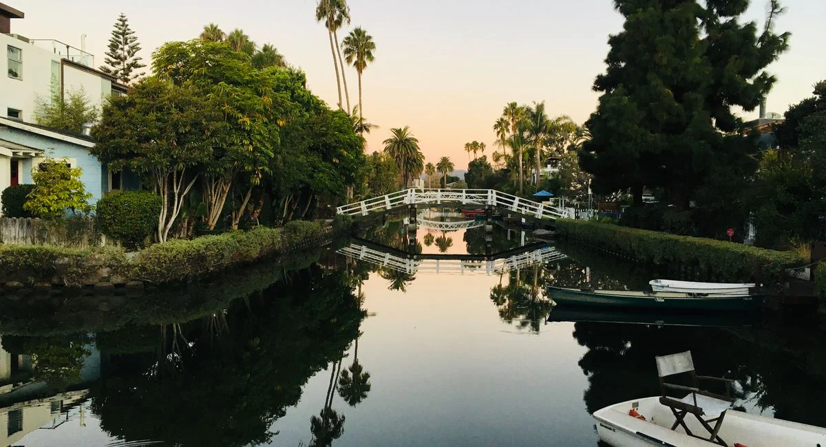 Serene view of the Venice Canals with a tranquil reflection at sunset.